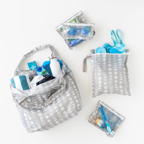 The Playdate Planner Deluxe 5-Piece Set: Lunar Phase by Bumkins—gray patterned bags, ideal for swim gear and travel organization.