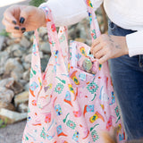 Close-up of a woman using Bumkins The Playdate Planner Deluxe 5-Piece Set: Boots to stay organized on the go.