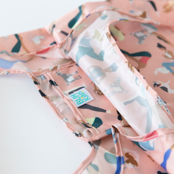 Close-up of Bumkins Packable Tote Bag: Yoga Pals on a white background, with focus on the interior pocket.