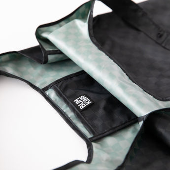 Close-up of a Bumkins Packable Tote Bag: Rich Black on a white background, with focus on the interior pocket.