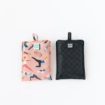 Two folded tote bags, including a Bumkins Packable Tote Bag: Rich Black, lay on a white background.
