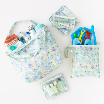 Bumkins The Playdate Planner Deluxe 5-Piece Set: Aloha Stitch holds toiletries and beach gear on a white background.