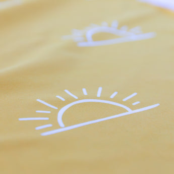 Close-up of the sun pattern on a Bumkins Reversible Roll & Go Blanket, Desert Boho, highlighting the soft fabric.