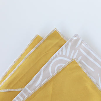 Close-up of a folded Bumkins Reversible Roll & Go Blanket, Desert Boho on a white background.