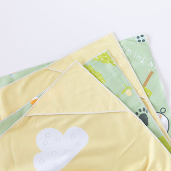 Close-up of a folded Bumkins Reversible Roll & Go Blanket, Happy Camper on a white background.