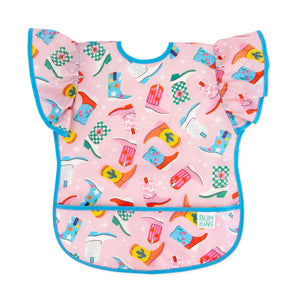 Bumkins Ruffle Apron Bib: Boots features pink waterproof fabric with a cowboy boot pattern, ruffle sleeves, blue trim, and front pocket.