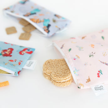 Bags from Bumkins Snack In Character 4-Piece Set: Disney Princess Magic Cinderella with snacks spilling out on a white background.