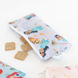 Close-up of bags from Bumkins Snack In Character 4-Piece Set: Disney Princess Magic Tiana with snacks spilling out on a white background.