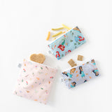 Bags from Bumkins Snack In Character 4-Piece Set: Disney Princess Magic Tiana hold snacks and a sandwich on a white background.