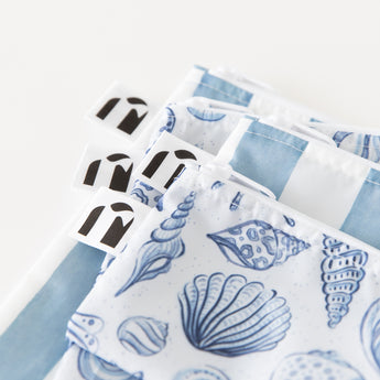 Close-up of Roamio by Bumkins Snack Bag 4 Pack: Coastal stacked on a white background, with focus on the zippers and logo label.