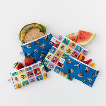 Bumkins Snack Bag 4 Pack: Mickey & Friends Excellent Eight, filled with snacks, is casually arranged on a white background.