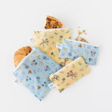 Bumkins Snack Bag 4 Pack: Mickey + Minnie Mouse Brunch Bunch lays overlapped on a white background, filled with breakfast foods.