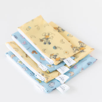 Bumkins Snack Bag 4 Pack: Mickey + Minnie Mouse Brunch Bunch lays neatly stacked on a white background.