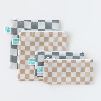 Five reusable zipper bags in various sizes with checkered patterns in gray and beige are arranged on a white background. A small tag with Bumkins is visible on each bag.