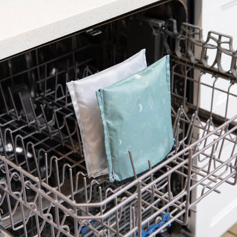 Bumkins Reusable Snack Bag, Large 2 Pack: Desert Night sits in the top rack of an open dishwasher.