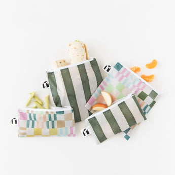 Bags from Bumkins Lunchbox Legends 6-Piece Set: Motley Green Jelly hold snacks on a white background.