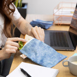 Close-up of a woman reaching for a sandwich from a bag from Bumkins Snack In Style 3-Piece Set: Denim On Denim.