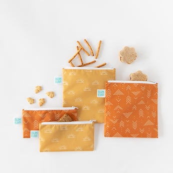 Bumkins Reusable Snack Bag 4 Pack: Desert Boho lays overlapped on a white background with snacks and sandwiches spilling out.