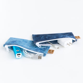 Roamio by Bumkins Reusable Snack Bag, Small 2 Pack: Denim on Denim lays open on a white background with electronics like cables inside.
