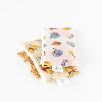 Bumkins Reusable Snack Bag 4 Pack: Disney Pooh Bear + Friends lays stacked on a white background; one is open with cookies inside.