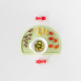 Bumkins Silicone Chewtensils®: Red is paired with Silicone Sensory Placemat: Sage and First Feeding Set: Vanilla Sprinkle on a white background.