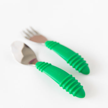 Close-up of Bumkins Spoon + Fork: Jade on a white background with focus on the handles.