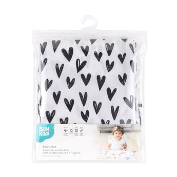 Bumkins Splat Mat: Hearts is shown folded in plastic packaging bag with a hanger and cardboard insert.