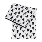Bumkins Splat Mat: Hearts—white, waterproof, black heart pattern, easy-wipe surface folded neatly.