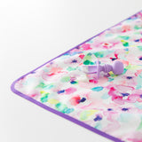 Close-up of a baby spoon with food on top of a Bumkins Splat Mat: Watercolor on a white background.