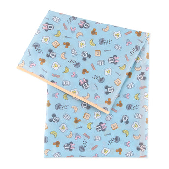 Bumkins Splat Mat: Mickey + Minnie Sunny Side Up, waterproof and stain-resistant, has a breakfast-themed print with Mickey and Minnie faces.