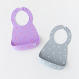 Bumkins Silicone Bib 2 Pack: Hearts and Rainbows lays flat on a white background.