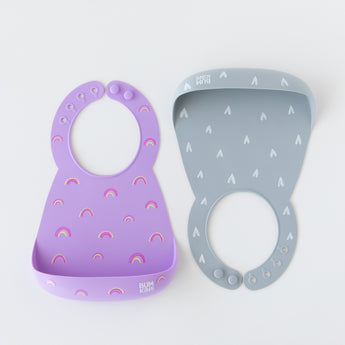 Bumkins Silicone Bib 2 Pack: Hearts and Rainbows is neatly arranged on a white background.