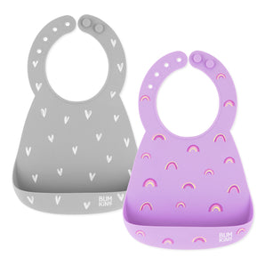 Bumkins Silicone Bib 2 Pack: Hearts and Rainbows includes 2 silicone bibs with catch-all pockets and adjustable closure in gray and purple.