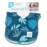 Bumkins Starter Bib 2-Pack: Dinosaurs & Blue Tropic, waterproof & machine washable, shown with a smiling toddler.