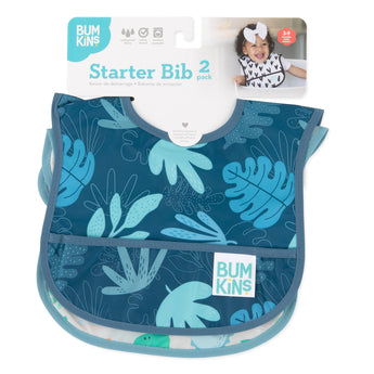 Bumkins Starter Bib 2-Pack: Dinosaurs & Blue Tropic, waterproof & machine washable, shown with a smiling toddler.