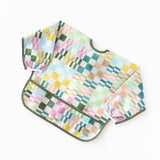 Bumkins Sleeved Bib: Motley Check rests on a white background.