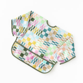 Bumkins Sleeved Bib: Motley Check rests on a white background.