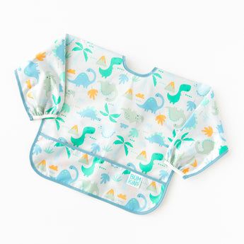Bumkins Sleeved Bib: Dinosaurs rests on a white background.