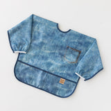 Bumkins Sleeved Bib: Vintage Denim rests on a white background.