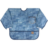 Bumkins Sleeved Bib: Vintage Denim features blue denim printed waterproof fabric with a pocket design, front pocket, & elastic cuffs.