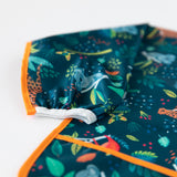 Close-up of a Bumkins Sleeved Bib 2 Pack: Jungle and Animal Print on a white background, with focus on the elastic cuff on the sleeve.