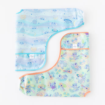 Bumkins Sleeved Bib 2 Pack: Stitch Star-ring Up Trouble lays folded on a white background.