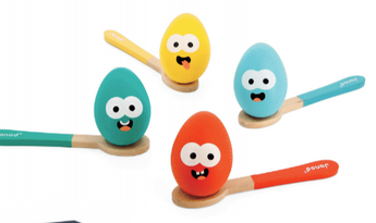 Janod Juratoys Egg and Spoon Race set includes colorful toy eggs with eyes and mouths on vibrant orange, yellow, teal, and blue spoons.