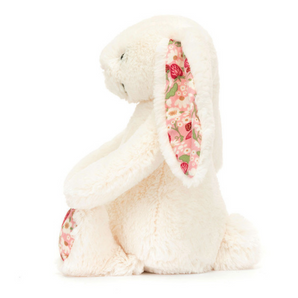 Side view of Jellycats Blossom Bunny Berry Little, featuring fluffy white fur with floral patterned ears and feet.