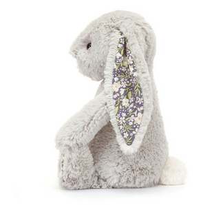 Side view of Blossom Bunny Silver, a plush gray bunny with floral ears and white tail by Jellycat—a perfect nighttime companion.