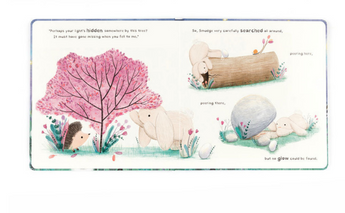In Jellycats Smudge Rabbit and the Falling Star book, Smudge Rabbit searches by a tree for a tale, but finds nothing near the log and rock.
