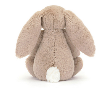 The Jellycat Blossom Bunny Petal Little has long ears and a white fluffy tail, showcasing the iconic Jellycat design.