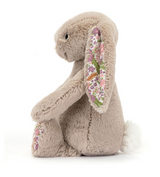Side view of a Jellycat, Blossom Bunny Petal Little with floral ears and feet, sitting upright on a white background.