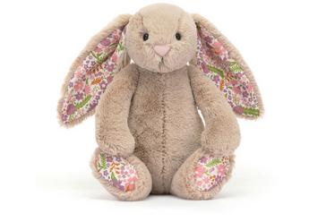 The Jellycat Blossom Bunny Petal Little has bashful beige fur, floral ears and feet, and sits upright.