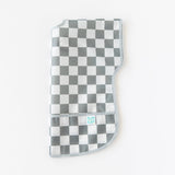 Bumkins Junior Bib: Charcoal Check is folded lengthwise on a white background.